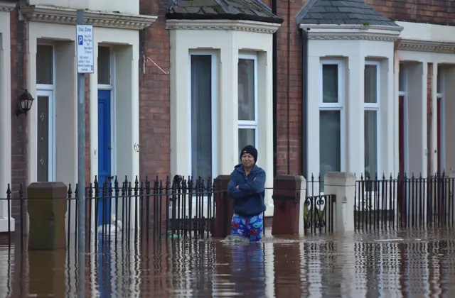 A man in floodwater in Carlisle