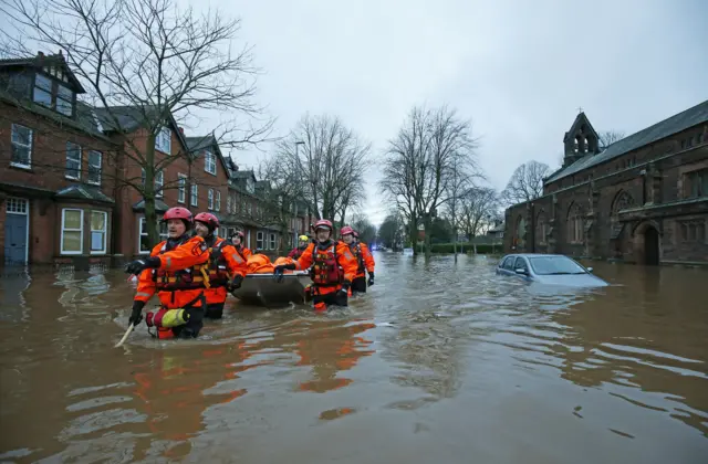 People in floodwater in Carlisle