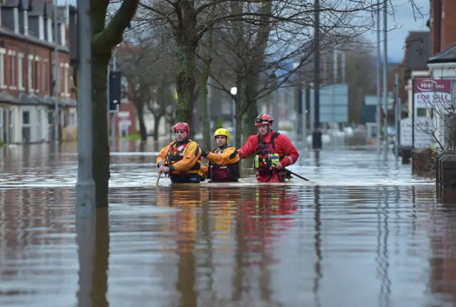 People in floodwater in Carlisle