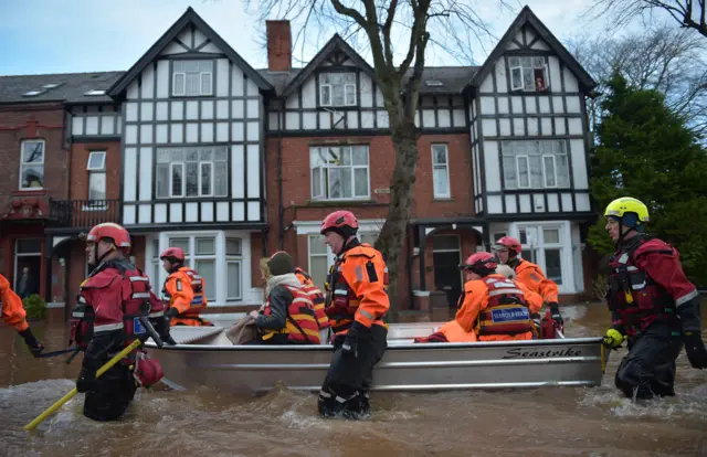 People in floodwater in Carlisle