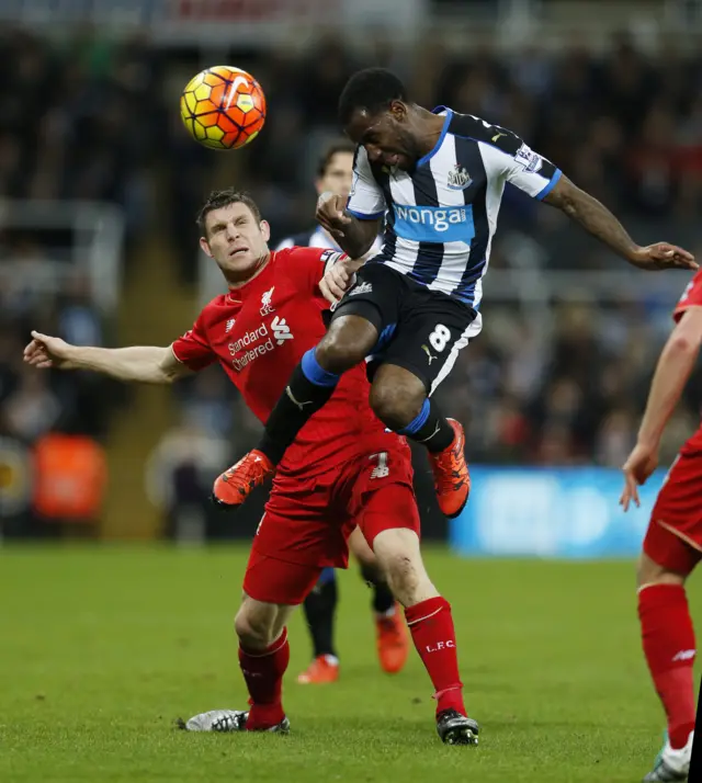 James Milner challenges for the ball