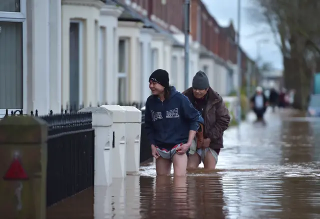 People in floodwater in Carlisle