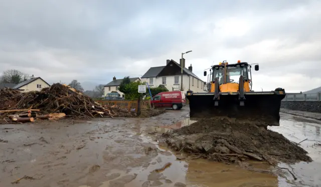 Debris being moved off a road in Keswick, northern England