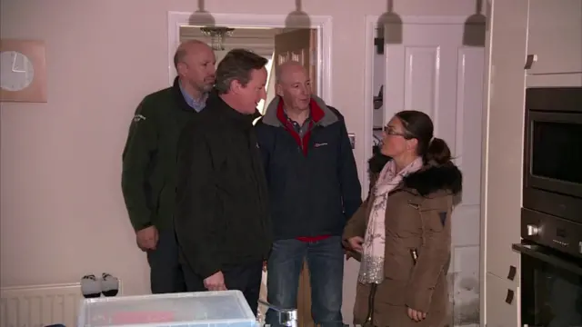 David Cameron visiting flood affected family