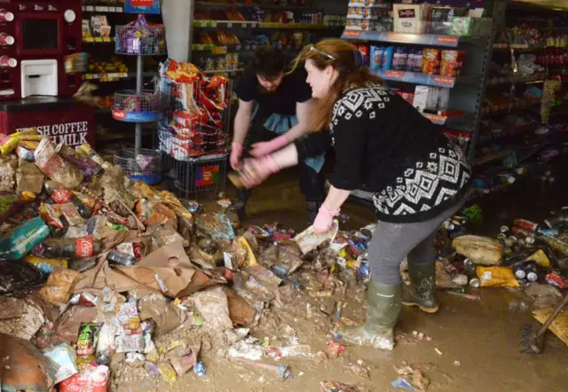 Shop workers clear-up in Cockermouth