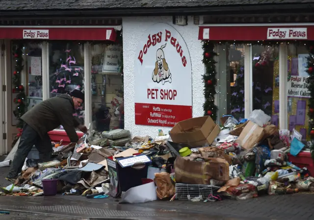 A man with flood-damaged goods in Keswick