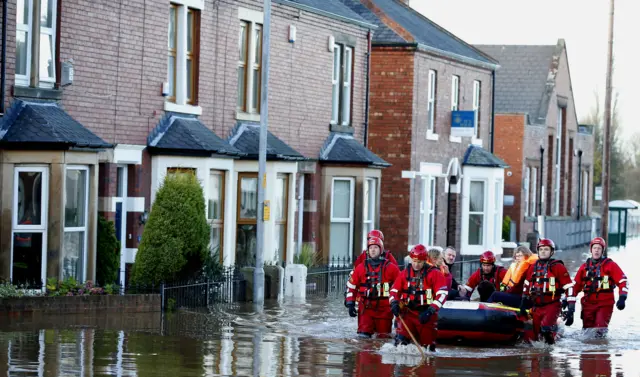 Rescue workers help residents to safety in Carlisle