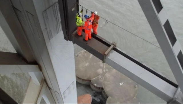 Workers looking at damage to Forth Road Bridge