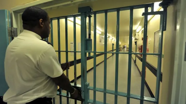 Guard locks gates in Wormwood Scrubs