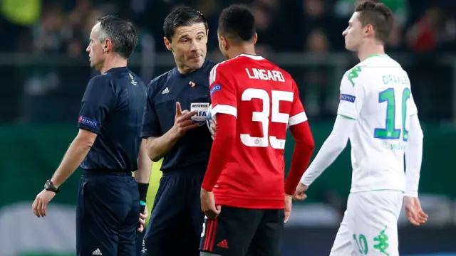 Jesse Lingard speaks with the referee