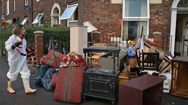 Woman taking possessions outside