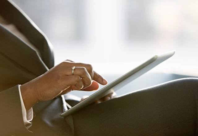 Person in suit with laptop on knee