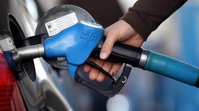 A person putting petrol in their car