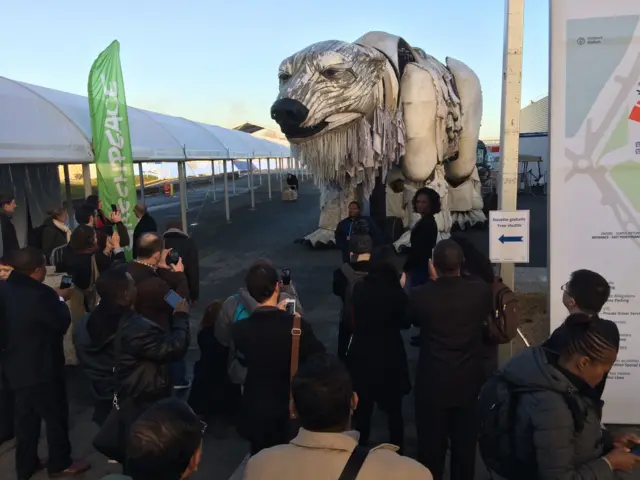 large mechanical polar bear with a crowd