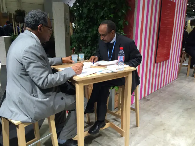 delegates reading the text at a table