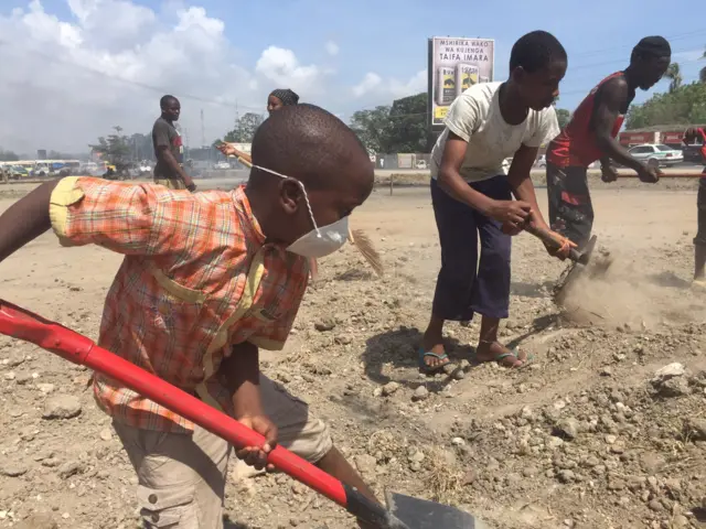 Children cleaning streets in Tanzania