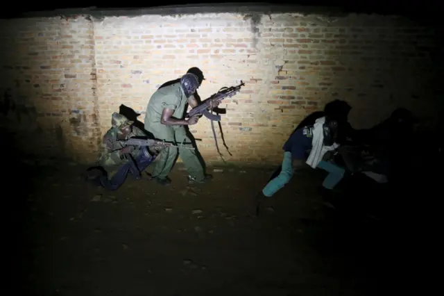 Armed vigilantes patrol in the center of Bujumbura, Burundi, November 20, 2015