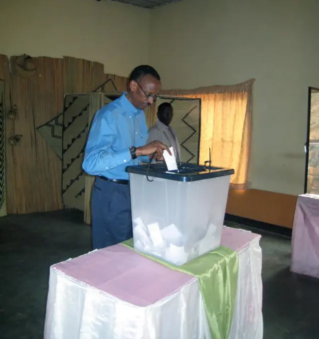 resident of Rwanda Paul Kagame (centre) puts his ballot in a voting box on September 15, 2008