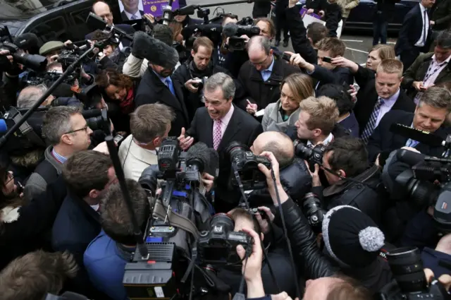 Nigel Farage surrounded by reporters