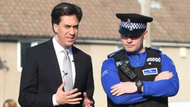 Labour leader Ed Miliband (left) talks to a police community support officer from Ollerton Police Station