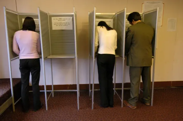 Voters in a booth