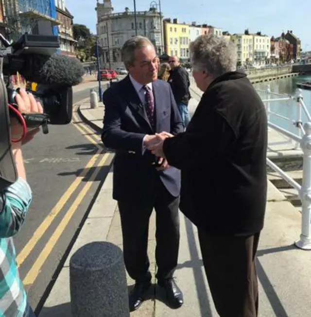 Nigel Farage shakes hands with a man in Ramsgate, Kent - 12 April 2015