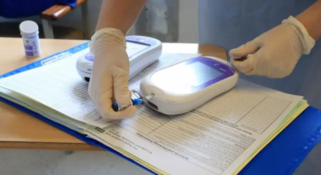 Nurse performs diabetes test