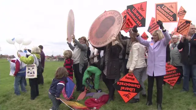 Protesters and supporters waiting for Nick Clegg