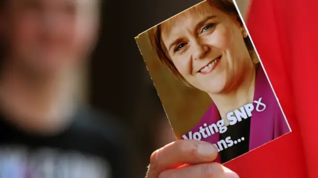 Nicola Sturgeon holding SNP leaflet