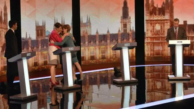 Leanne Wood, Natalie Bennett and Nicola Sturgeon take part in a group hug, as Ed Miliband and Nigel Farage stand apart