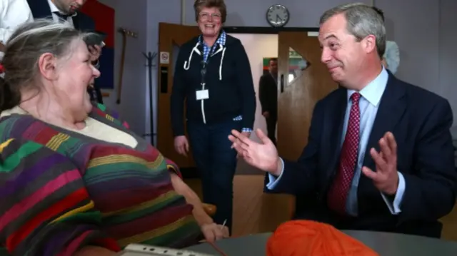 Nigel Farage, right, chatting at a campaign event