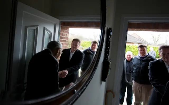 A voter greets Grant Shapps and Conservative candidate for Wells James Heappey in Street, Somerset