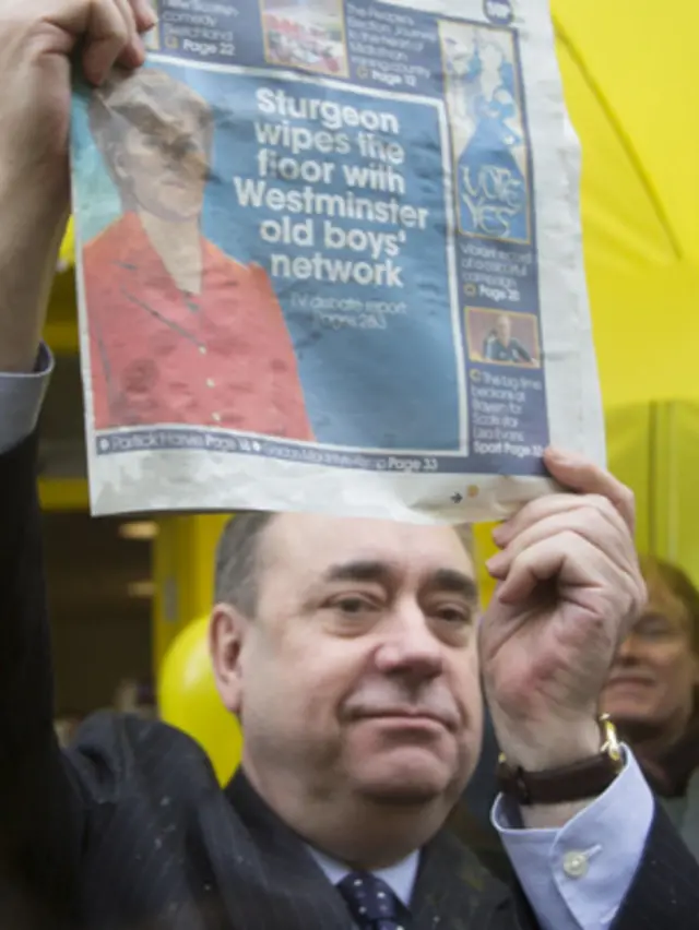 Alex Salmond holds aloft a newspaper proclaiming Nicola Sturgeon's debate success