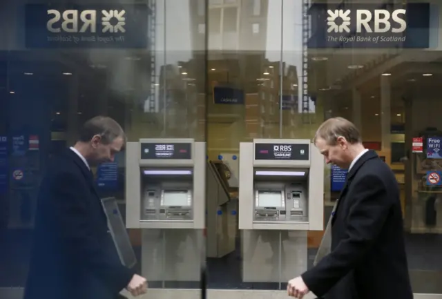 A man walks past an RBS branch