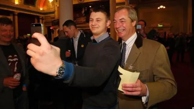 Nigel Farage posing for a selfie