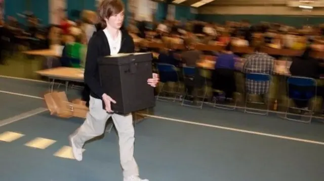 Ballot boxes are run in during the Sunderland election count in 2010