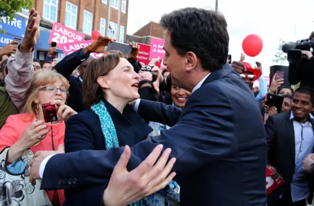 Ed Miliband and his wife, Justine, hug on a campaign visit