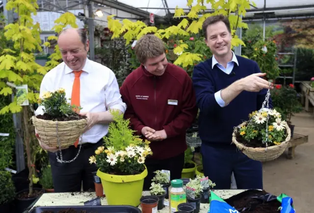 Nick Clegg and Lewes parliamentary candidate Norman Baker plant hanging baskets during a campaign visit