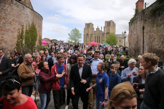 David Cameron surrounded by a crow in Wells