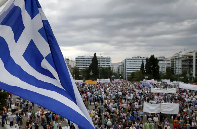 Greek flag waves over a protest march