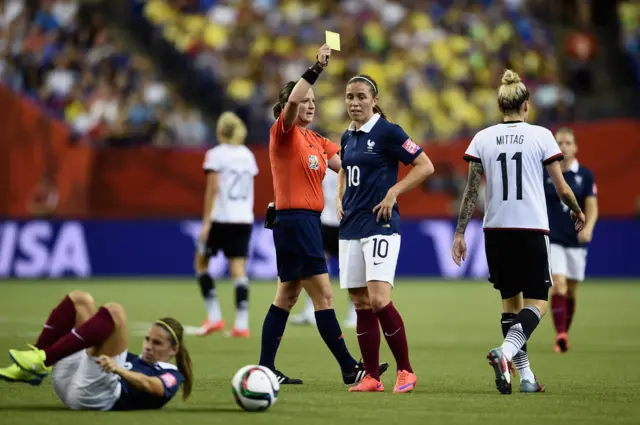 Anja Mittag is shown a yellow card