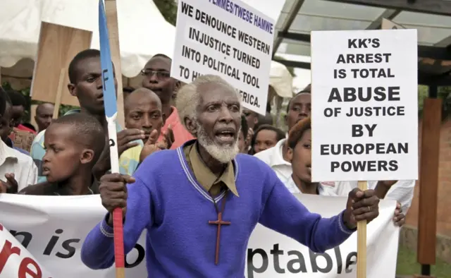 Demonstrators march to the British High Commission, to protest the arrest in the UK of Rwandan spy chief Emmanuel Karenzi Karake, in the capital Kigali, Rwanda Thursday, June 25, 2015