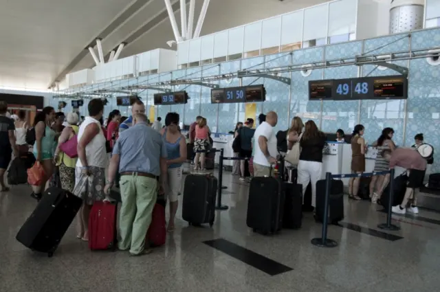 Tourists wait to check in for their flight to Manchester, Britain, at the Enfidha international airport, Tunisia on 27 June