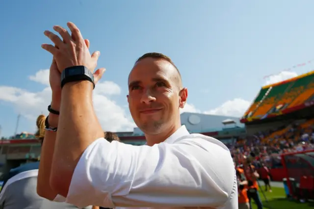 Mark Sampson applauds