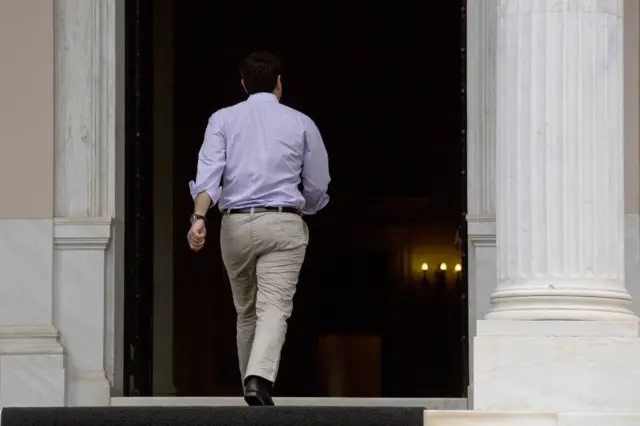 Greece"s Prime Minister Alexis Tsipras arrives at his office in Athens, Saturday, July 11, 2015