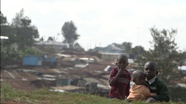 Children on a hill next to Kibera