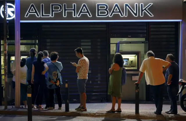 People waiting to get into a Greek bank