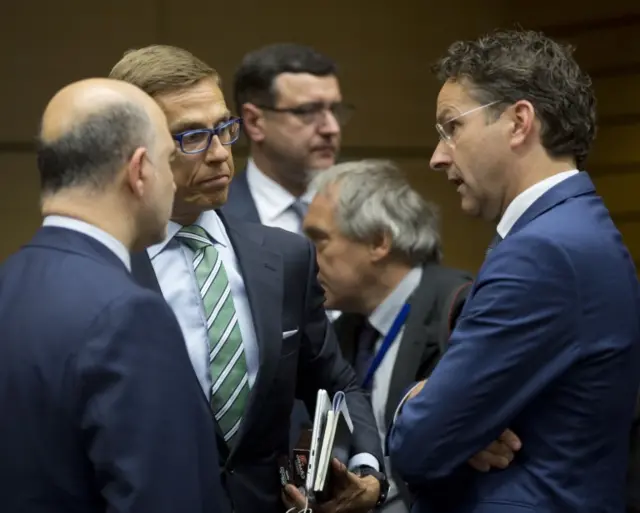 Dutch Finance Minister and chairman of the eurogroup Jeroen Dijsselbloem, right, speaks with European Commissioner for the Economy Pierre Moscovici, left, and Finnish Finance Minister Alexander Stubb, second left