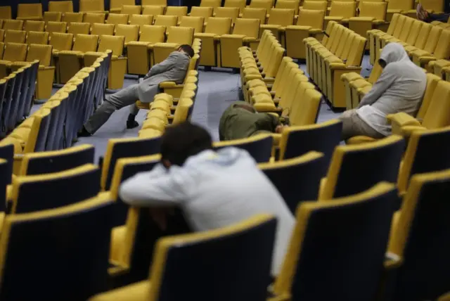 Journalists wait for the end of Eurozone leader summit on the Greek crisis