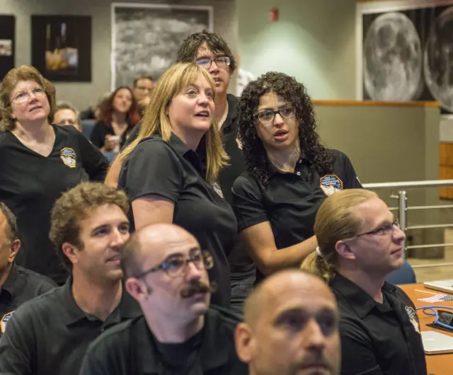 New Horizons team members await news